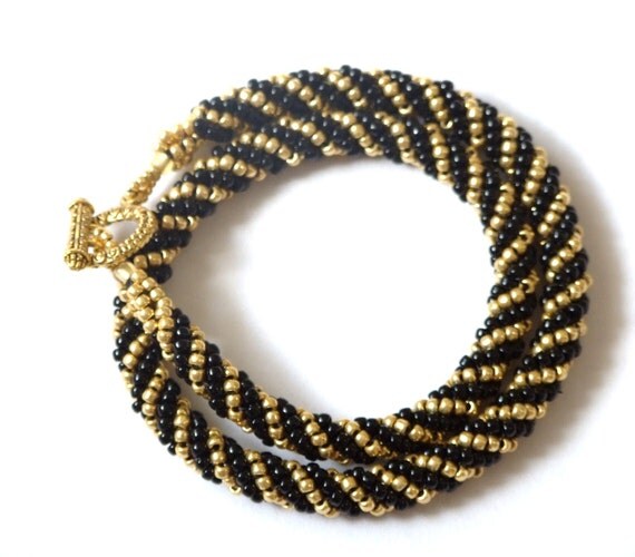 Items similar to Black and gold beaded cord necklace on Etsy