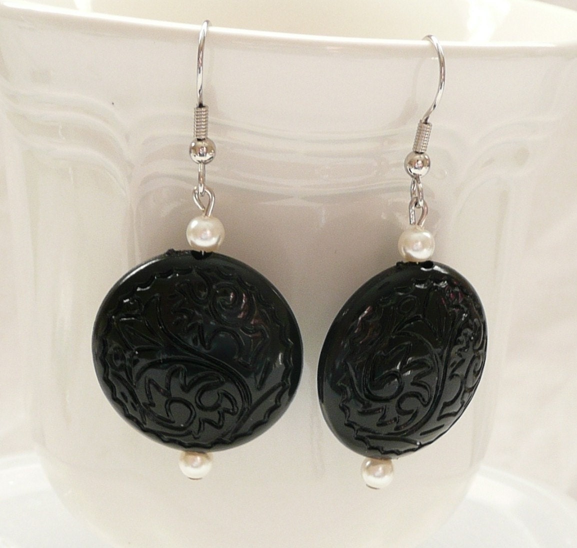 ndbBlack Carved Round Dangle Earrings Accented with White