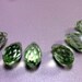 12mm X 7mm Swarovski light green faceted teardrops. 6 crystal Beads