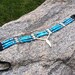 Bone hair pipe choker, blue speckle bone, bone feather, hand cut leather, blue, black, cream, pow wow regalia, dance intertribal