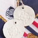 Rustic Clay Compass Tags. Hand stamped Ornaments Set of 2