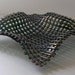 WoVeN FuSeD GlAsS ArT DiSh in A GoRgEoUs OrGaNiC ShApE and ShiMmEriNg GrEEn IriDeScEnt GlAsS