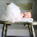 Newborn baby tutu classique perfectly proportioned with blossom hair clip. Soft ethereal tutu in classic ivory and nursery decoration.