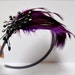 Plum purple headband-jeweled feathers. A chic classic with starburst spray of lavender and grey rhinestones.