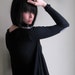 Still Waiting - Black asymmetrical sweater with elbow patches