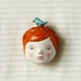 FREE SHIPPING Redhead doll face and bird - ooak brooch - wearable art - sculpted paper clay pin