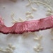 23 1/2" of Ribbonwork french silk ruffle with metal edge