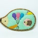 Wishes of a playful hedgehog felt pin