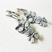 vintage figural owl clip on earrings in a silver tone