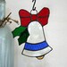 Christmas ornament, Holidays, stained glass bell with blue accent, red bow, green holly leaves hanging decoration suncatcher