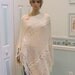 Creme/ivory, poncho,for a med. to large sized woman, hand knitted in a cable pattern, with 5" fringe