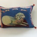 Large blue jazzy lion with curtain and poof. Its a silk cushion or pillow