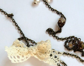 Antique brass swallow and lace necklace