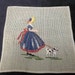 vintage needlepoint with girl and her dog, unfinished background