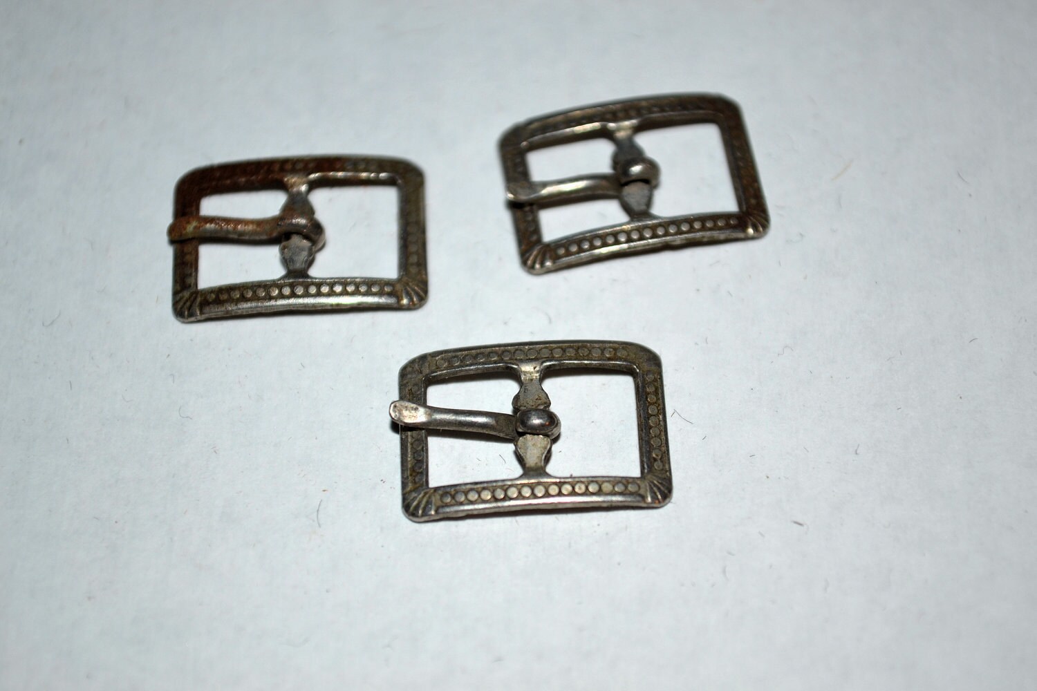 Three miniature vintage belt buckles