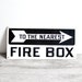 vintage industrial black and white "to the nearest firebox" arrow sign