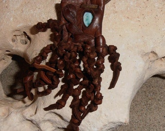 Free Flow- This Wisdom Pod is made out of Brown Leather and features a polished piece of Larimar