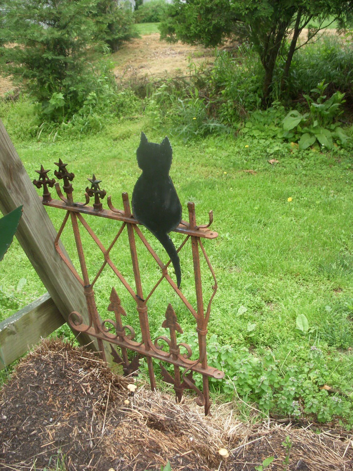 Metal Art Black Cat on Wrought Iron Fence in Garden