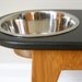 Elevated feeder with painted top and bamboo legs