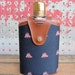 vintage c. 1960s nautical flask // glass with faux leather and sailboat fabric jacket