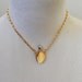 Vintage Secret Perfume Bottle necklace pendant 1970s. Gold metal Oval bottle with separate stopper on chain. Unworn.