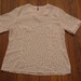 women's vintage pink polka dot blouse.