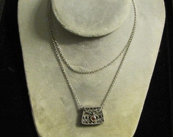 A sterling silver purse necklace