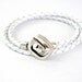 Double wrapped white braided leather bracelet with spiral toggle clasp