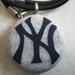 New York Yankees hand carved on a grey granite color background. Pendant comes with a FREE 3mm leather necklace