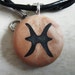 Zodiac PISCES signs hand carved on a polymer clay copper pearl color background. Pendant comes with a FREE 3mm necklace.