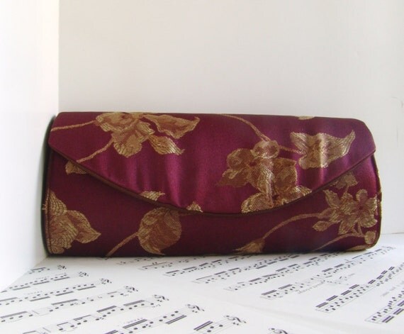 burgundy and gold clutch bag