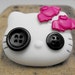 Gothic / Emo Hello Kitty brooch with buttons in her eyes and fuchsia bats on ther head