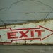 rusty and crusty tin EXIT sign