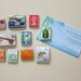 10 Recycled postage stamp magnets, India Portugal Poland Hungary England Australia Canada Japan New Zealand. Item#SM12