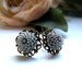 the petite gray pom stud earrings.