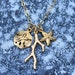 Charmed by the Sea Necklace in Gold w/ Sand Dollar, Coral, & Starfish
