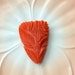 Bakelite Deeply Carved Dress Clip Salmon Color