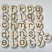 Magnets Featuring Graphic Letters of the Alphabet on Recycled Foreign Language Text for Home Office Decor