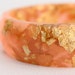 strawberry pink multifaceted eco resin bangle with metallic gold flakes