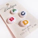 Buttons, ABC in primary colors on white ceramic buttons on a card, alphabet, green, red, blue and yellow