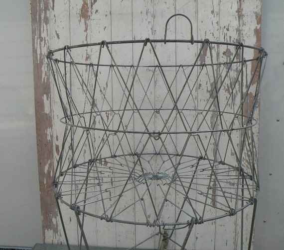 Vintage wire collapsible laundry basket . On castors for easy