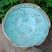 A Sgraffito Etched Serving Bowl displaying a bird and vines