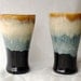 A Pair of Black and Tan Tumblers