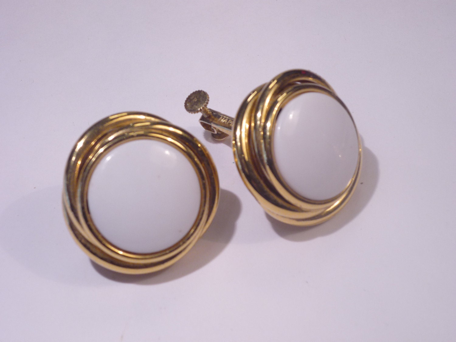 Vintage Napier adjustable clip earrings with white centers.