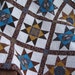 Mahogany and Teal Stars Quilted Table Topper