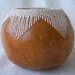 Small gourd bowl with stitched and woven V pattern at rim. 1608