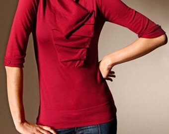 A beautiful red blouse with an asymmetrical collar.