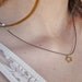 necklace with golden flower on black thread ,ROMANTIC