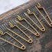 Set of 10 antique brass brooch back pins, clasps from 1920-1930s