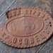 Antique brass plate, primitive licence number.